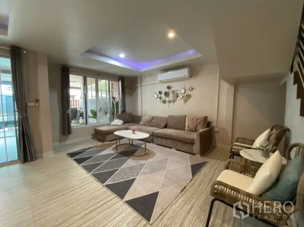 联排别墅 出租或出售 - 宽敞起居区，转角沙发、大窗与空调。