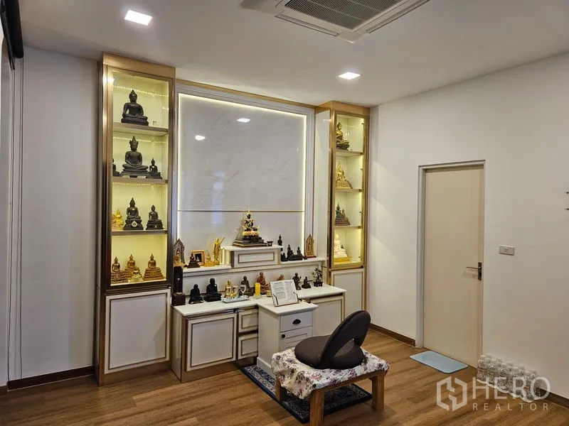 Detached House for sale in Thawi Watthana, Bangkok - Dedicated prayer room with built-in illuminated display shelves and altar cabinetry.