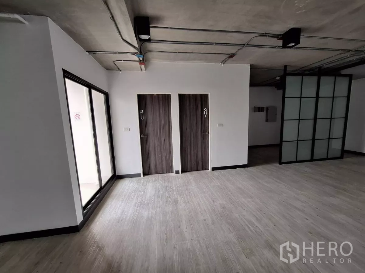 Office Space for rent in Watthana, Bangkok - Entrance zone with two restroom doors and a frosted glass partition wall.