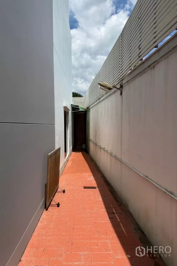 Detached House for sale - Narrow service walkway with privacy wall and terracotta tiles along the house.