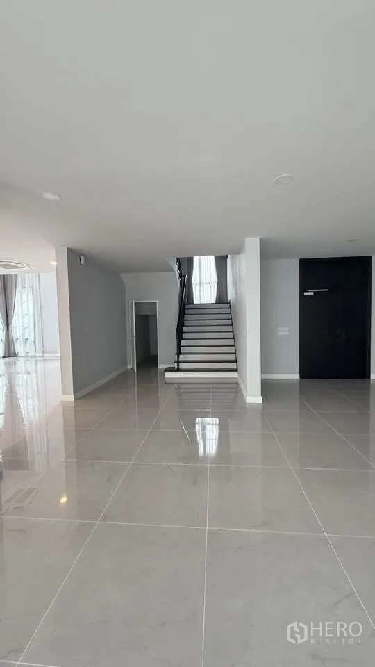 Detached House for rent in Bang Phli, Samut Prakan - Open-plan area with staircase view and polished tile floors.