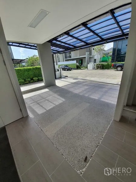 Detached House for sale in Bang Khun Thian, Bangkok - Covered carport with polycarbonate roof and driveway.