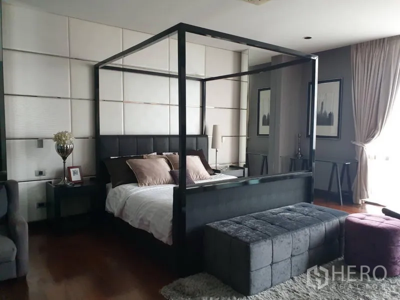 Detached House for sale in Watthana, Bangkok - Master bedroom with four-poster bed, upholstered bench and large windows.