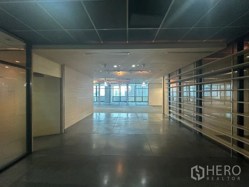 Office Space for rent in Khlong Toei, Bangkok - Entrance lobby with polished concrete floors, ceiling lights, and glass walls leading to bright office space.
