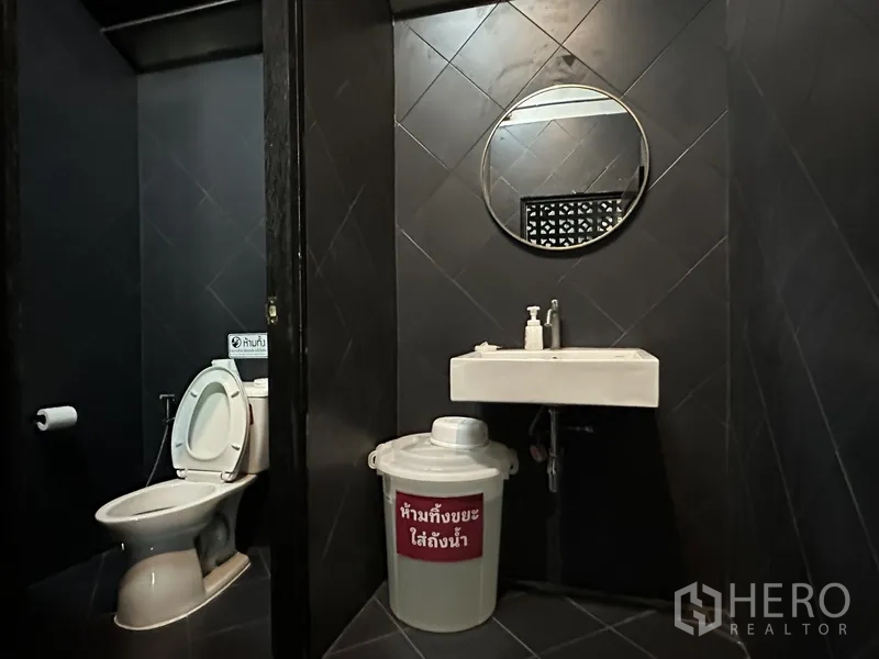 Retail Space for rent in Phra Khanong, Bangkok - Two restroom stalls with round mirror and square basin.
