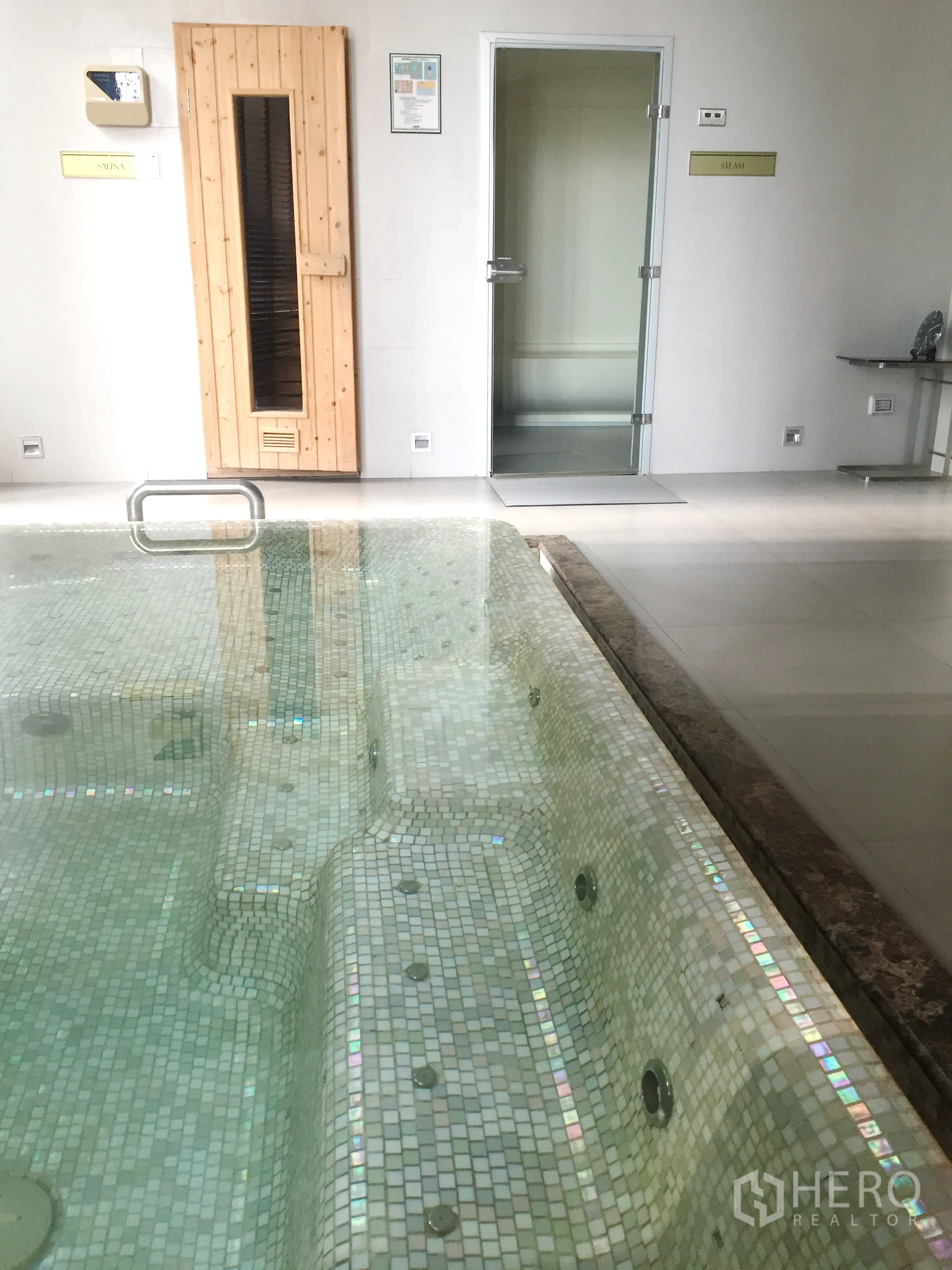 Condominium for rent in Pathum Wan, Bangkok - Indoor jacuzzi with mosaic tiles beside sauna and steam rooms.