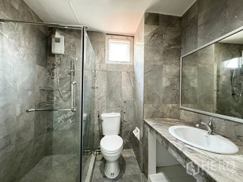 ทาวน์เฮาส์ ให้เช่าหรือขายในSuan Luang, Bangkok - ห้องน้ำโทนหินอ่อนสีเทาพร้อมตู้กระจกกั้นอาบน้ำและเคาน์เตอร์ยาว