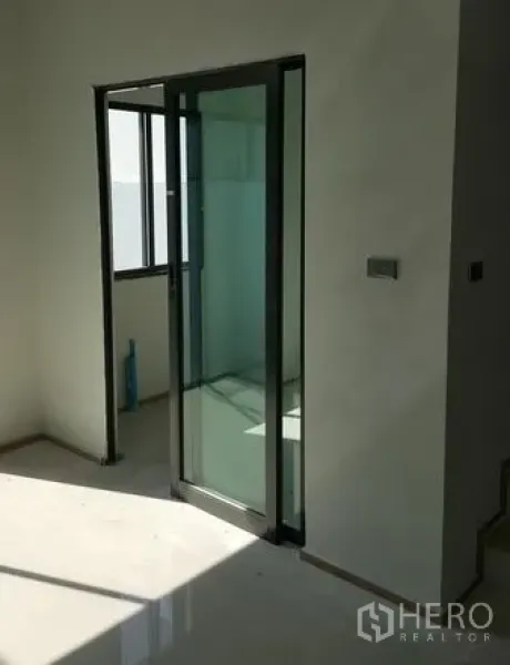 ทาวน์เฮาส์ ให้เช่าในBueng Kum, Bangkok - พื้นที่ภายในรับแสงพร้อมประตูกระจกบานเลื่อนและหน้าต่าง โทนสีขาวมินิมอล