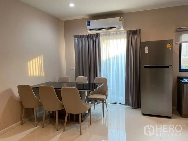 Townhouse for rent - Bright dining area with six-seat table, full-length curtains and a wall-mounted air conditioner.