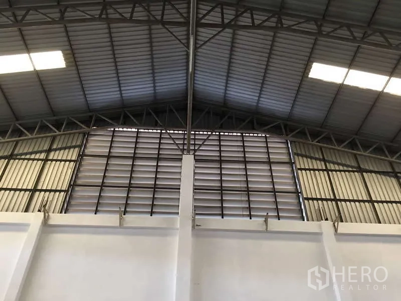 Factory for rent in Bang Bo, Samut Prakan - Gable wall with louvered ventilation beneath an arched metal roof.