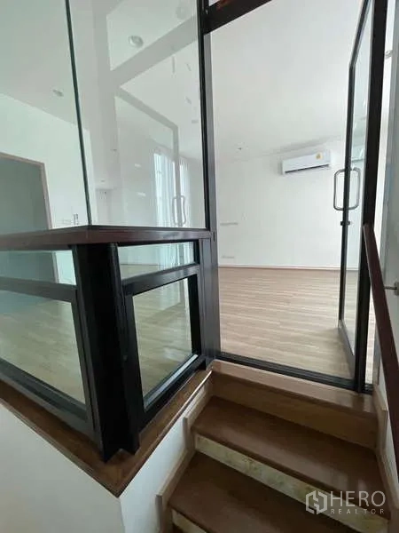 สำนักงานที่บ้าน ให้เช่าหรือขายในWang Thonglang, Bangkok - ชานบันไดกั้นกระจกและบันไดไม้ขึ้นสู่ชั้นบน