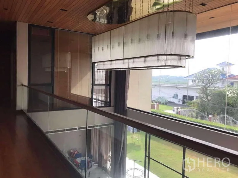 Detached House for rent in Bang Phli, Samut Prakan - Upper hallway with glass balustrade and statement chandelier
