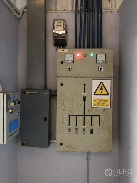 Factory for sale in Pathum Thani - Electrical control panel and high‑voltage switchgear inside a service room.