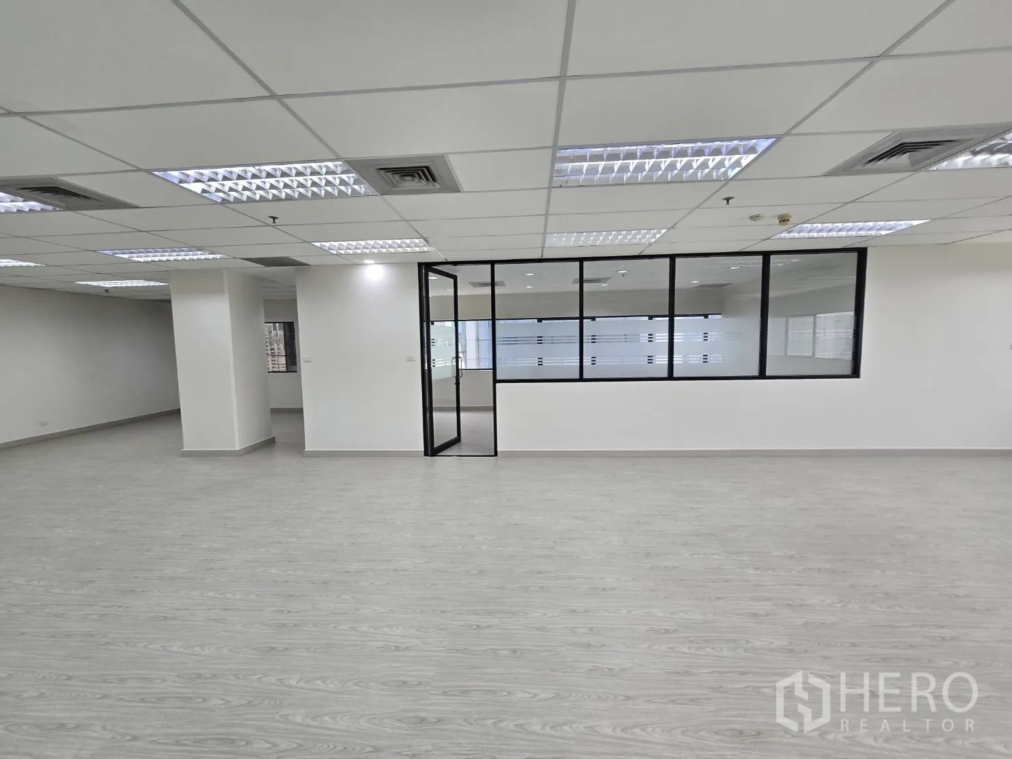 Office Space for rent in Khlong Toei, Bangkok - Open office with large interior glass window and door connecting rooms.
