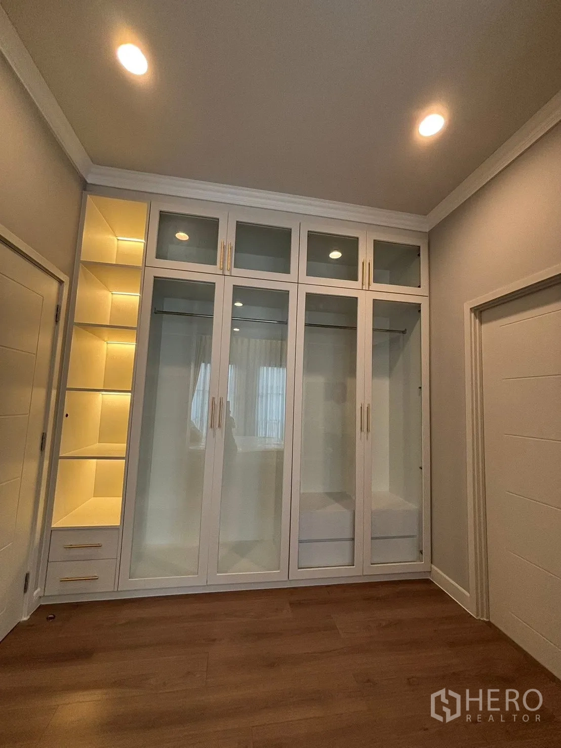 独立式住宅 出租在Bang Phli, Samut Prakan - 内置白色衣柜，玻璃柜门与柔光灯带。