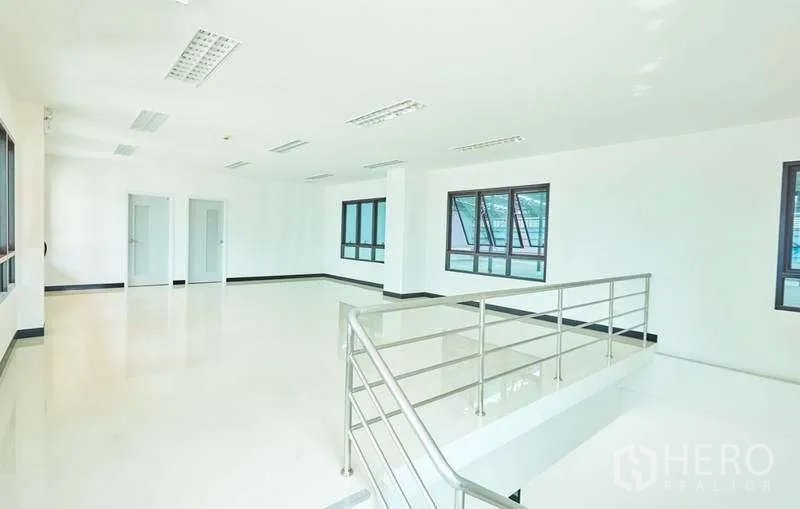 Factory for rent in Bang Phli, Samut Prakan - Large upstairs office area with natural light and stainless handrail