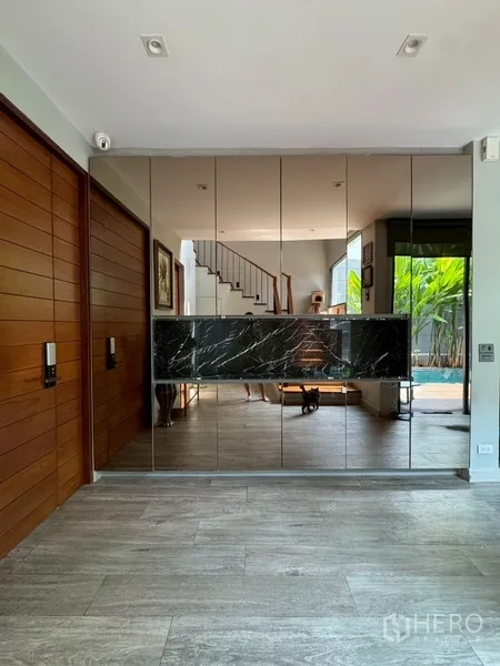 Semi-detached House for rent in Watthana, Bangkok - Entry hall with full-height mirrored wall facing the pool and stairs.