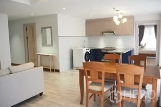 Condominium for rent in Pathum Wan, Bangkok - Dining area next to kitchen with washer and ceiling lights in the condo.