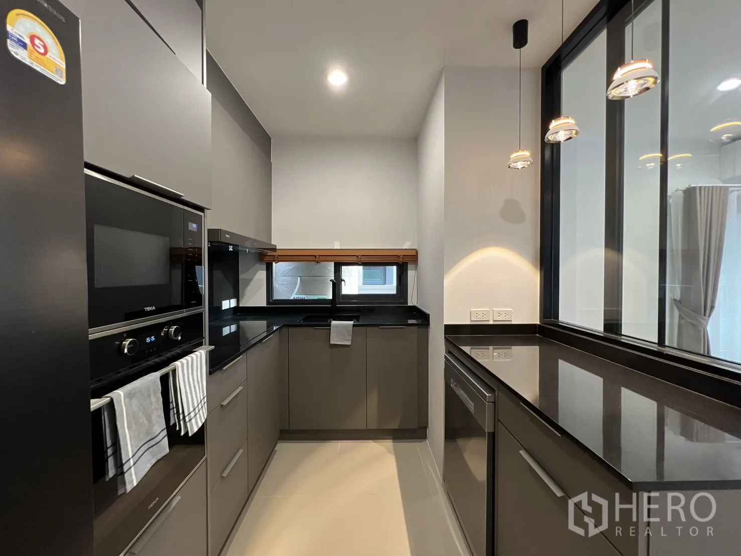 Detached House for rent in Prawet, Bangkok - Modern Kvik-style kitchen with Teka built-ins and black countertops.