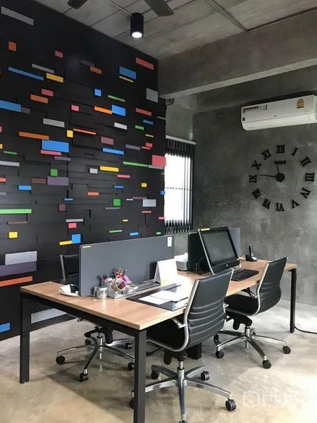 Office Space for rent in Bang Kapi, Bangkok - Open‑plan office with two desks, a colorful feature wall and concrete finishes.