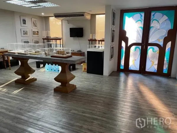 Office Space for rent in Khlong Toei, Bangkok - Lobby or showroom with wood floors and stained-glass double doors.