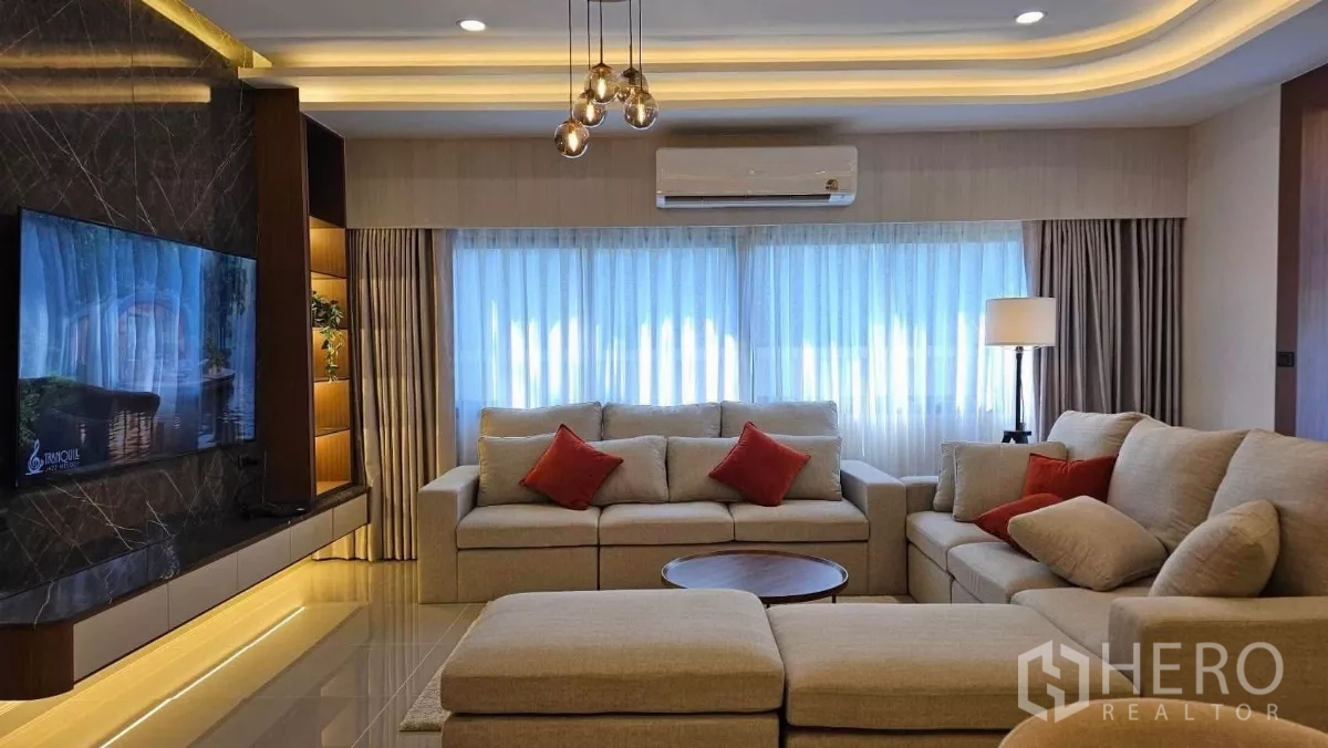 Detached House for rent in Bang Phli, Samut Prakan - Spacious lounge featuring a dark marble TV wall and L‑shaped sofa under recessed lights.