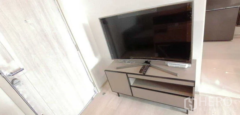 คอนโด ให้เช่าหรือขายในPathum Wan, Bangkok - ทีวีจอแบนตั้งบนชั้นวางในห้องนั่งเล่นสว่าง