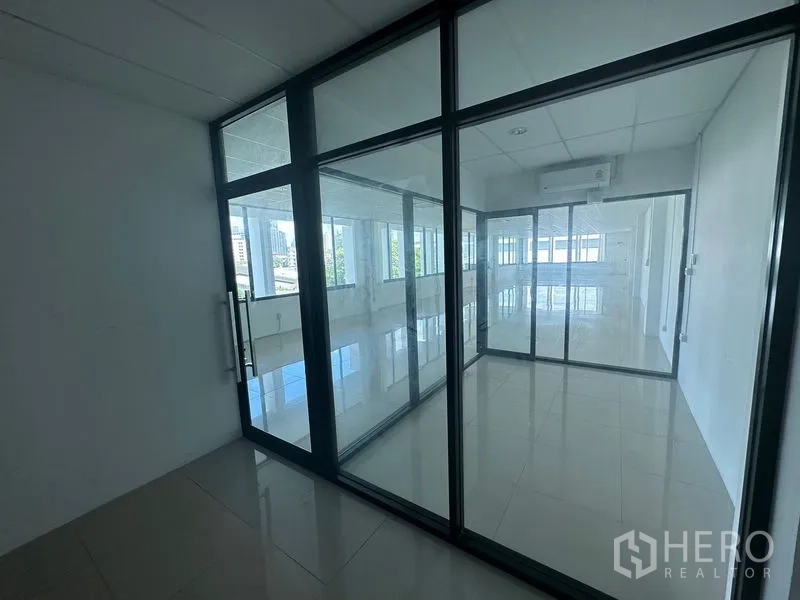 Office Space for rent - Private meeting room enclosed by black-framed glass panels with air conditioning.