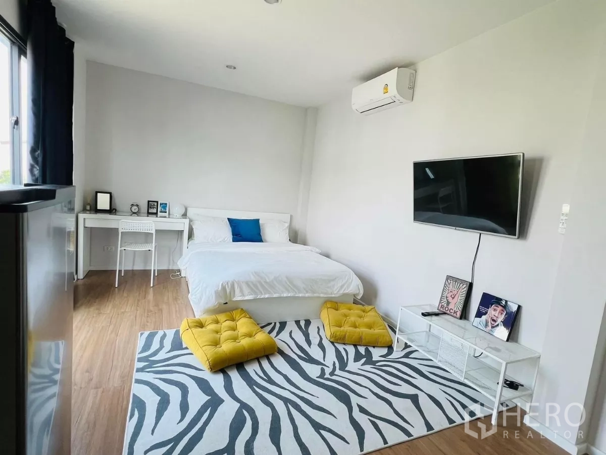 บ้าน ให้เช่าในSaphan Sung, Bangkok - มุมห้องนอนมาสเตอร์ เตียง ทีวี และโต๊ะทำงานริมหน้าต่าง.