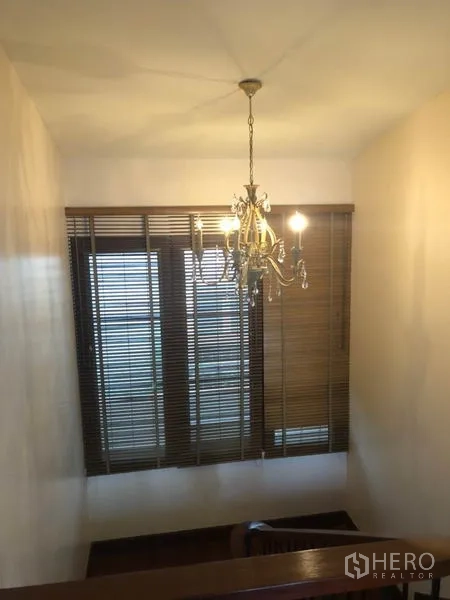 Detached House for rent in Watthana, Bangkok - View down the staircase with chandelier and venetian blinds.