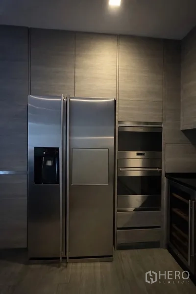 Semi-detached House for rent in Watthana, Bangkok - Stainless double-door fridge and built-in oven stack in the kitchen.