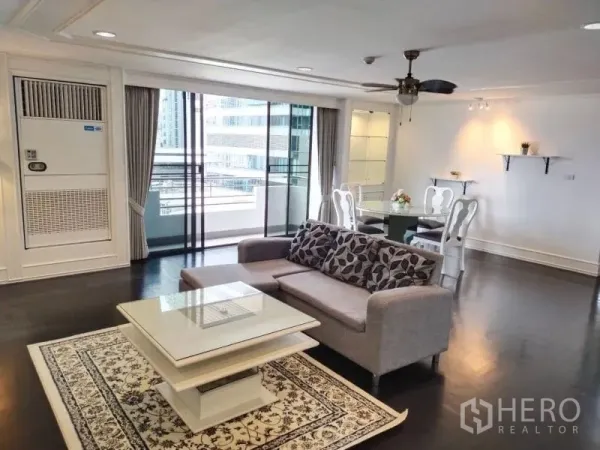 Condominium for rent in Sathon, Bangkok - Open-plan lounge and dining space with glass doors to the balcony and urban views.