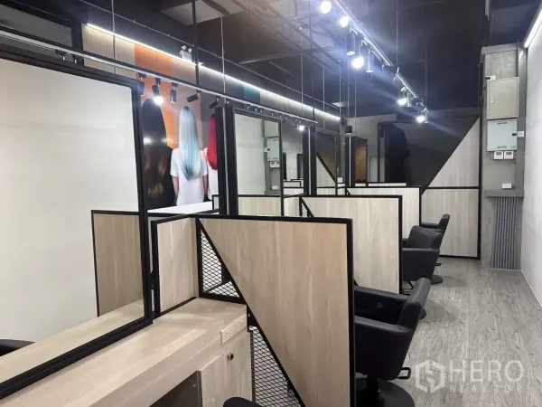 Retail Space for rent in Mueang Nakhon Pathom, Nakhon Pathom - Multiple styling booths with mirrors, power outlets and black chairs along the wall.