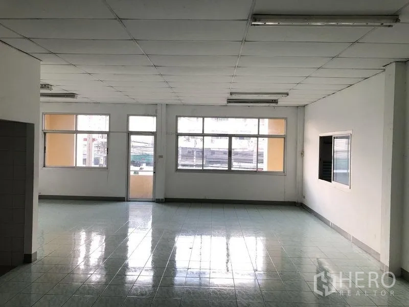 Factory for rent in Pathum Thani - Bright upper-floor office with large windows and glossy tiled floor.