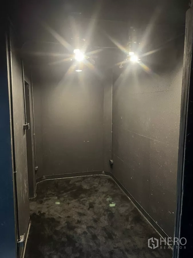 Home Office for rent in Wang Thonglang, Bangkok - Small acoustic booth with dark carpet and ceiling lights.