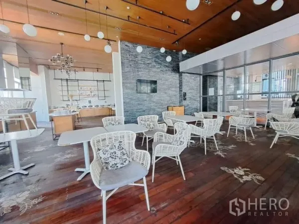 零售空间 出租在Watthana, Bangkok - 咖啡馆式座位区，面对石材装饰墙与服务台