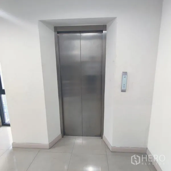Office Space for rent in Bang Kho Laem, Bangkok - Stainless steel passenger elevator in a clean corridor.