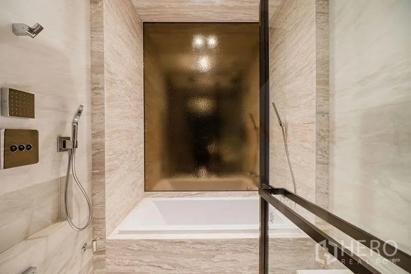 Condominium for rent - Luxury bathroom with soaking tub, stone walls and handheld shower.