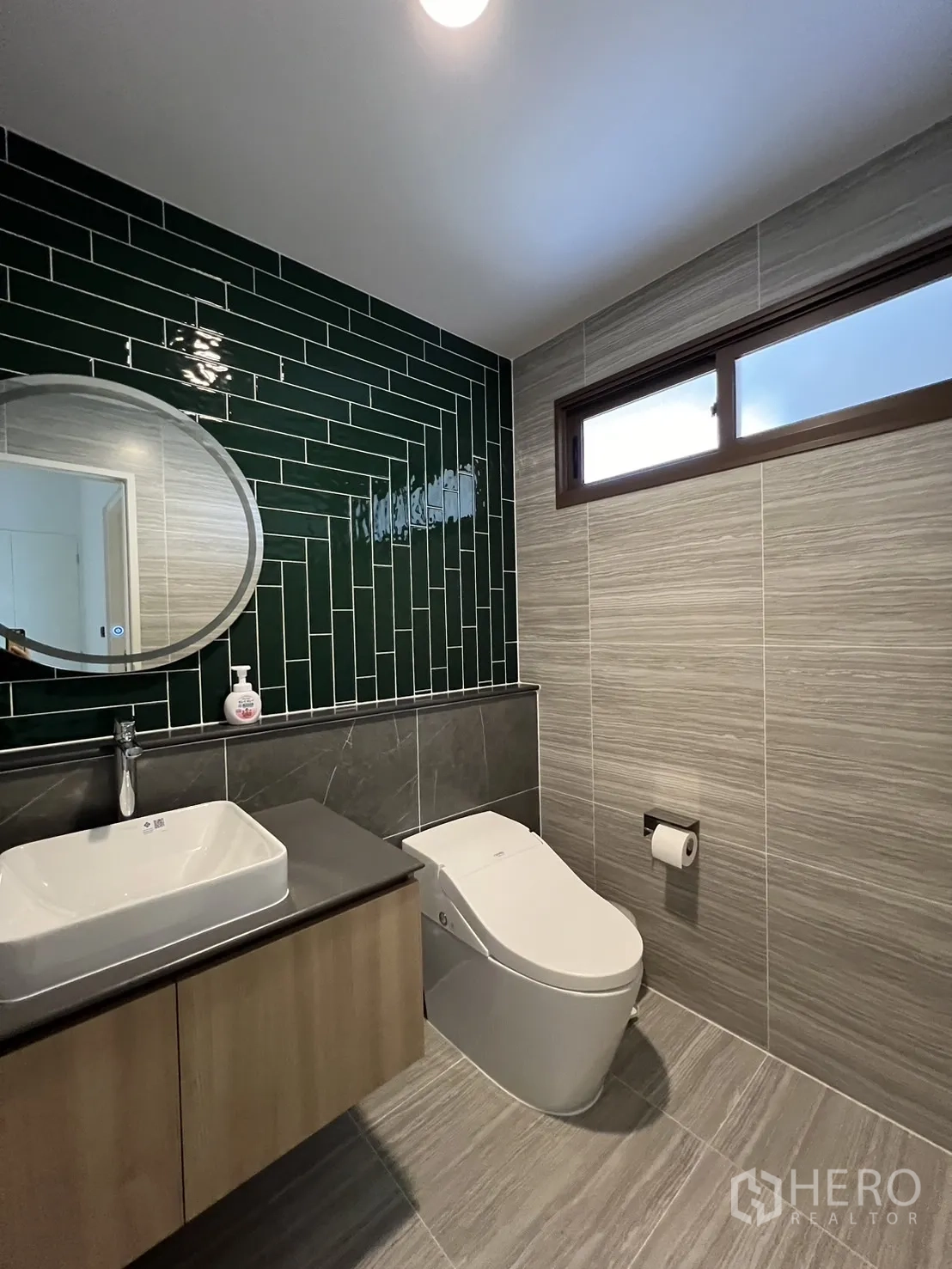 Detached House for rent or sale in Bang Kapi, Bangkok - Stylish powder room with green subway tile wall, vanity and smart toilet.