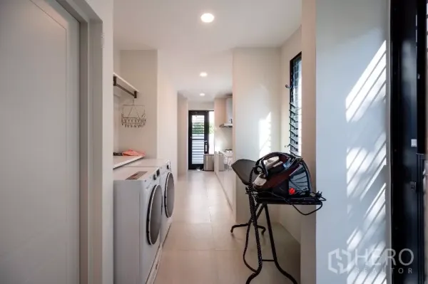 Detached House for rent or sale in Khlong Toei, Bangkok - Utility room with washer and dryer, ironing station and a rear door.