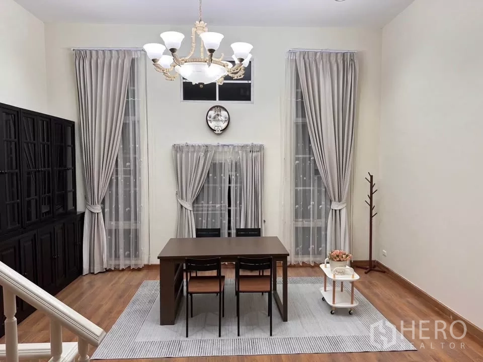 Townhouse for rent in Bang Kho Laem, Bangkok - Another angle of the dining hall showing chandelier, long curtains and staircase detail.