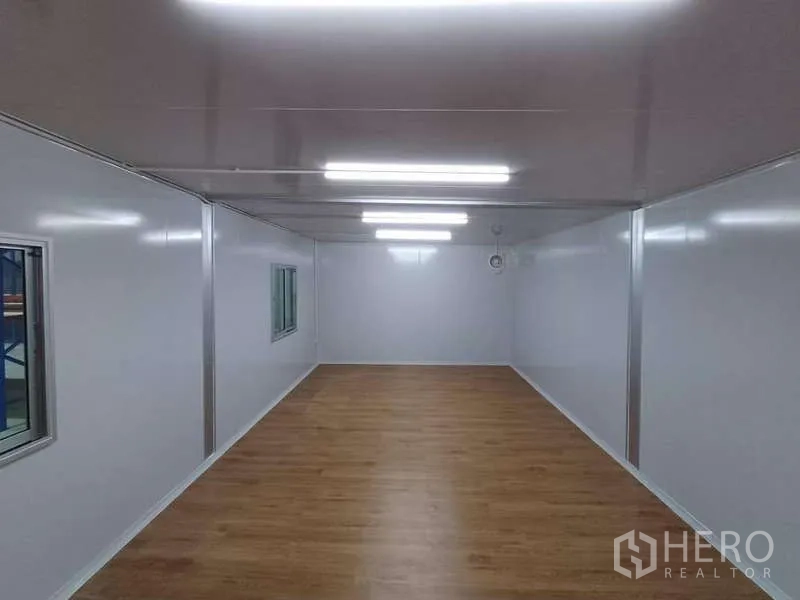 Warehouse for rent in Rat Burana, Bangkok - Bright office interior with white walls, LED lighting and wood-look flooring inside the warehouse.