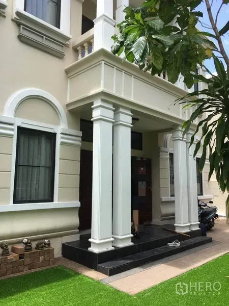 Detached House for rent in Khlong Toei, Bangkok - Grand covered porch with tall columns and a dark wood front door.
