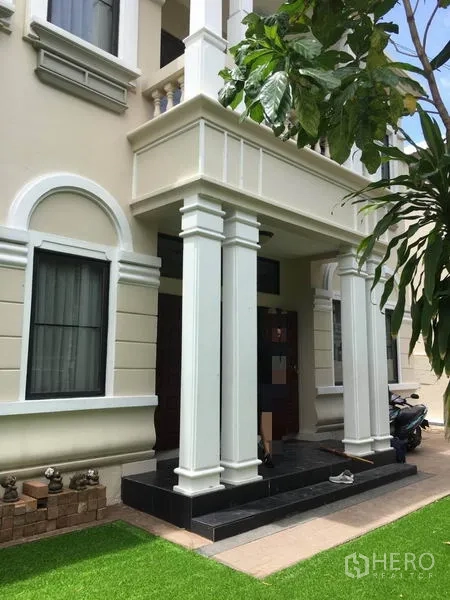 Detached House for rent in Khlong Toei, Bangkok - Grand covered porch with tall columns and a dark wood front door.