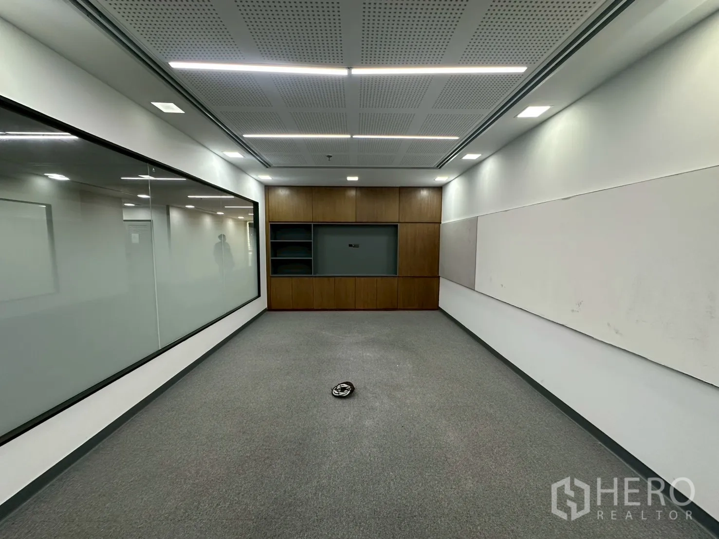 Office Space for rent - Meeting room with acoustic perforated ceiling, whiteboards and wood built-ins.