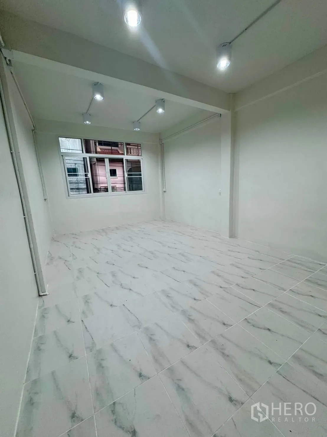 Shophouse for rent in Sathon, Bangkok - Deep ground-floor area with lighting and stairway at the rear.