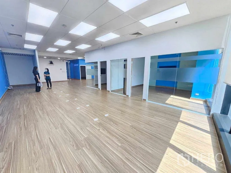 Office Space for rent in Sathon, Bangkok - Spacious office floor with glass partitions and floor boxes under bright ceiling lights.