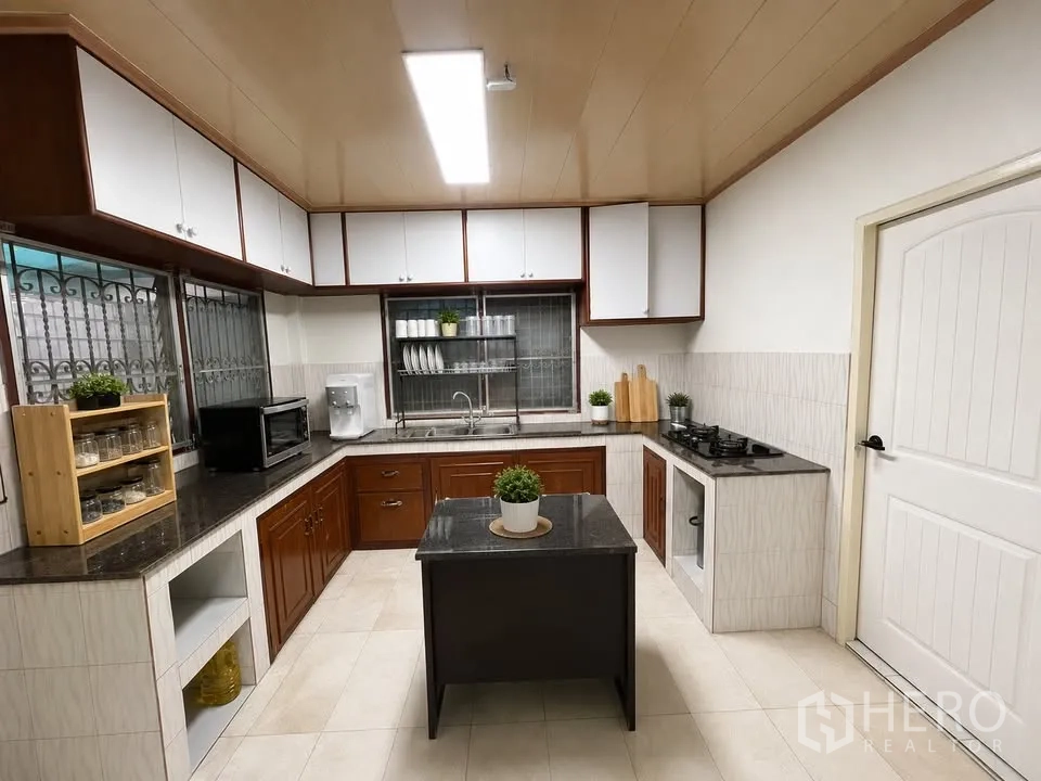 Detached House for rent in Prawet, Bangkok - Fitted kitchen with cabinets, window, gas hob and center island.
