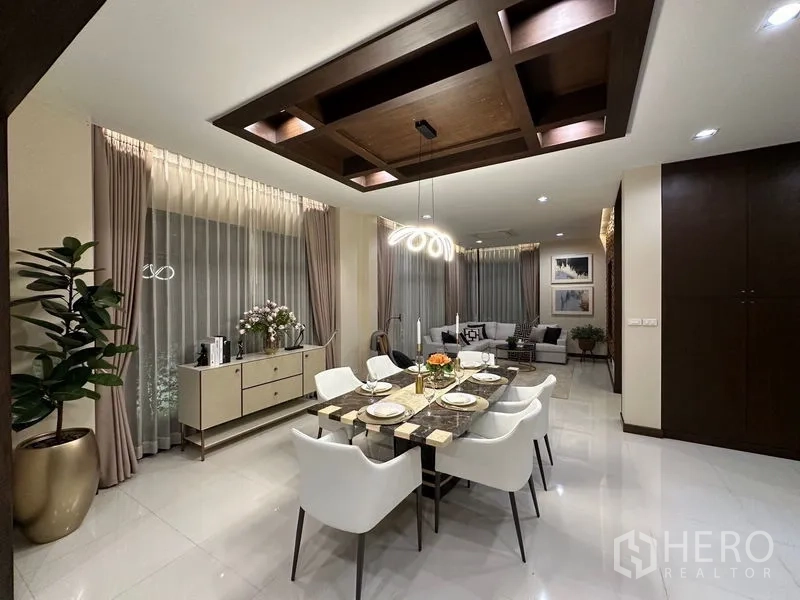 独立式住宅 出租 - 优雅餐厅，岩板餐桌、白色餐椅与雕塑感吊灯。