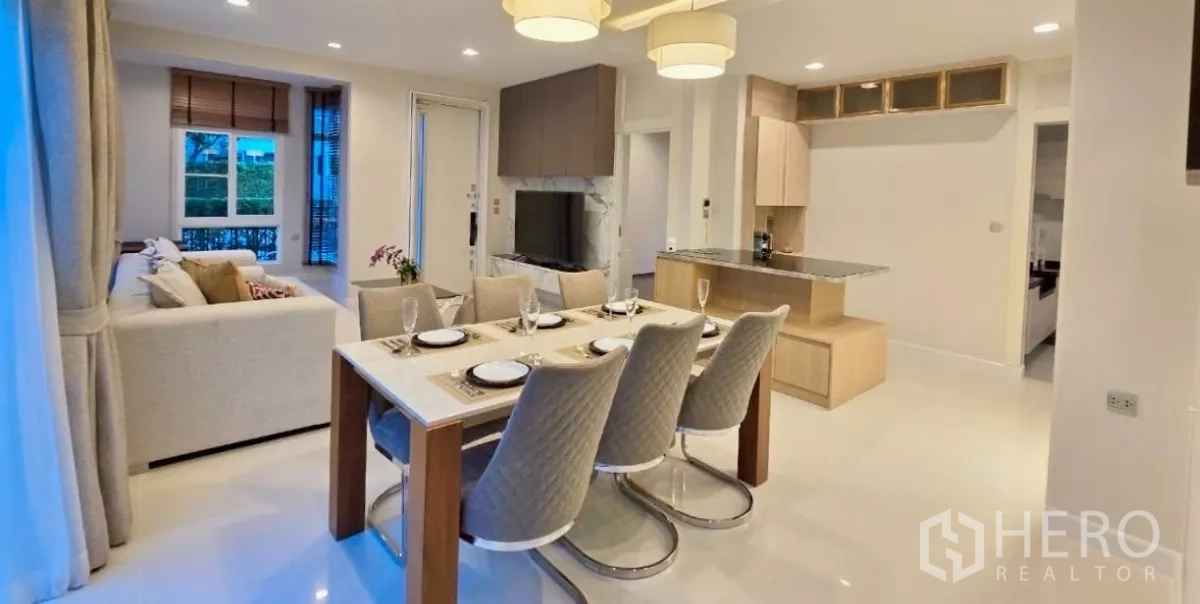 Detached House for rent in Samut Prakan - View from the kitchen island toward the dining table and TV feature wall.